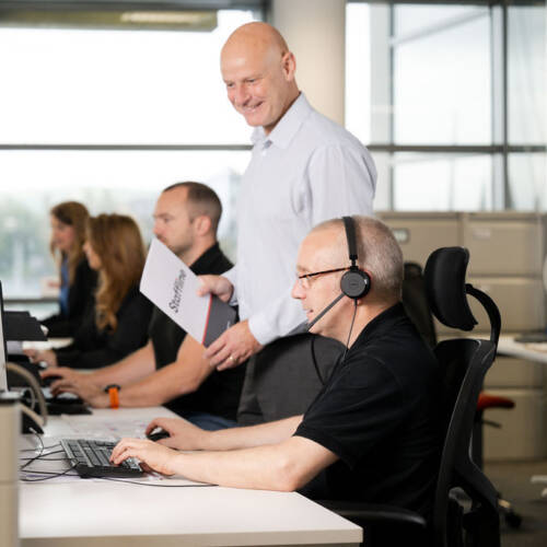 Staffline team member wearing headset and making calls