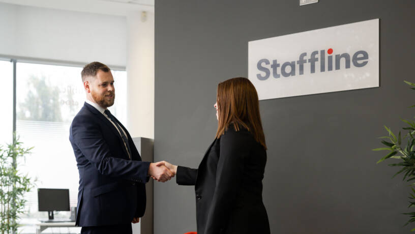 Two people shaking hands in Staffline office