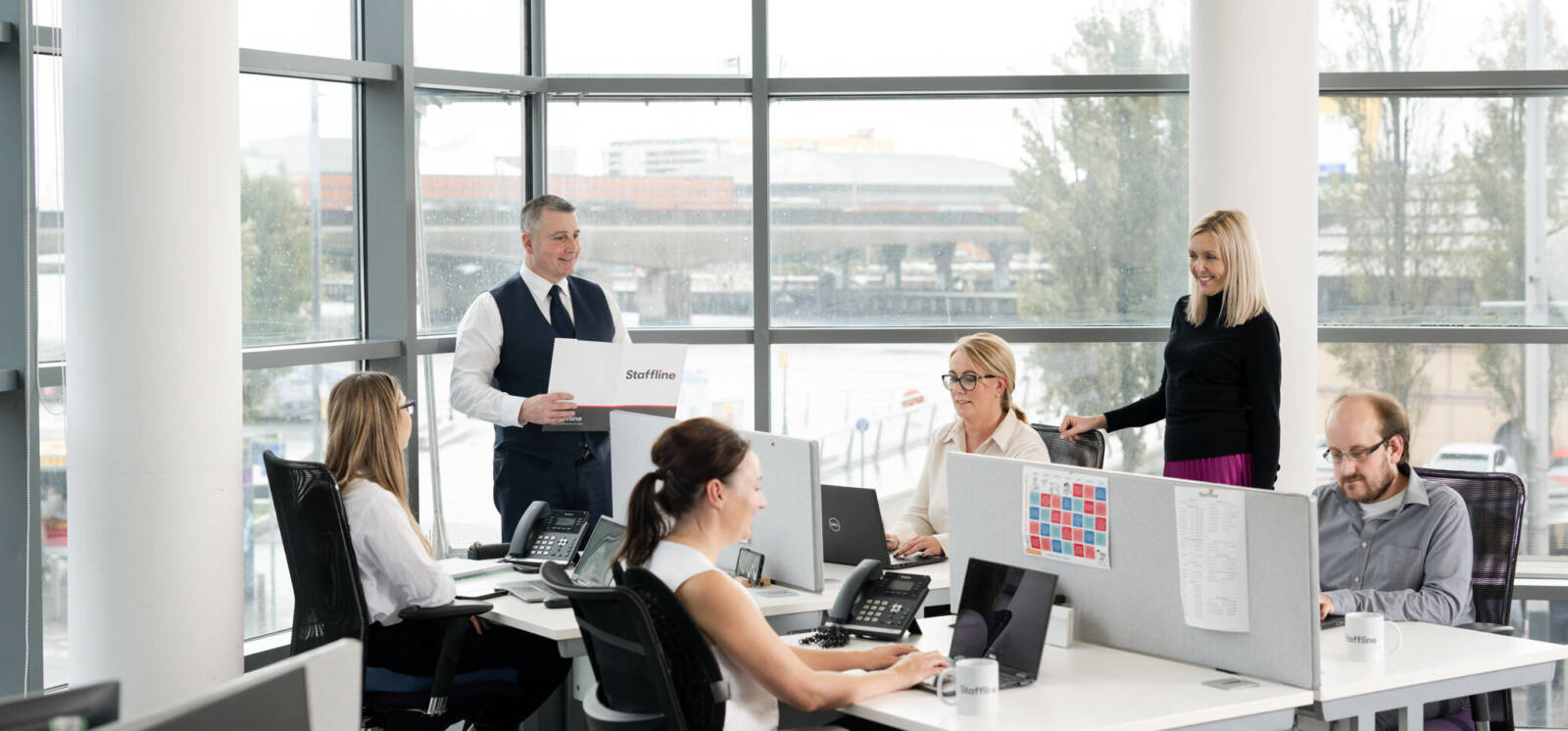 Several Staffline team members working in their office